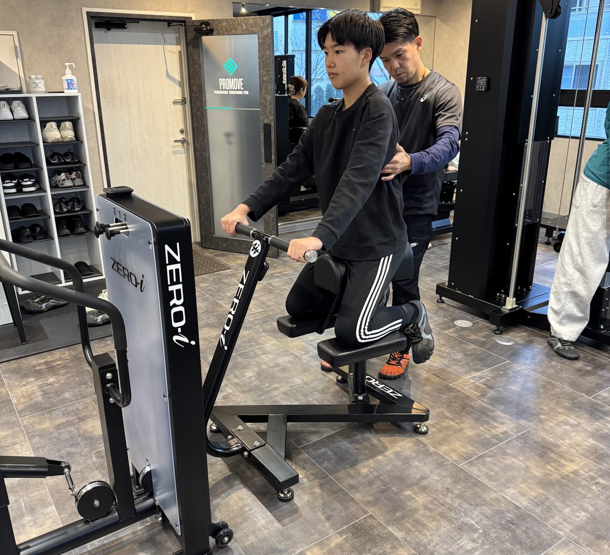 トレーナーが会員様の動きを横で確認している